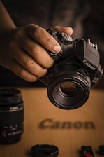 person holding black nikon dslr camera