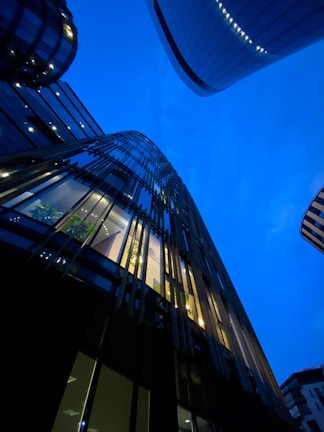 Evening shot of Antwerp’s skyline with deep royal blue sky and illuminated modern architecture.