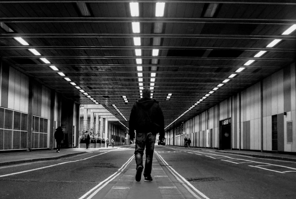 man in black jacket walking on the street