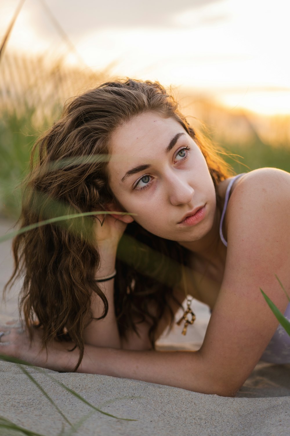 woman in green tank top lying on ground