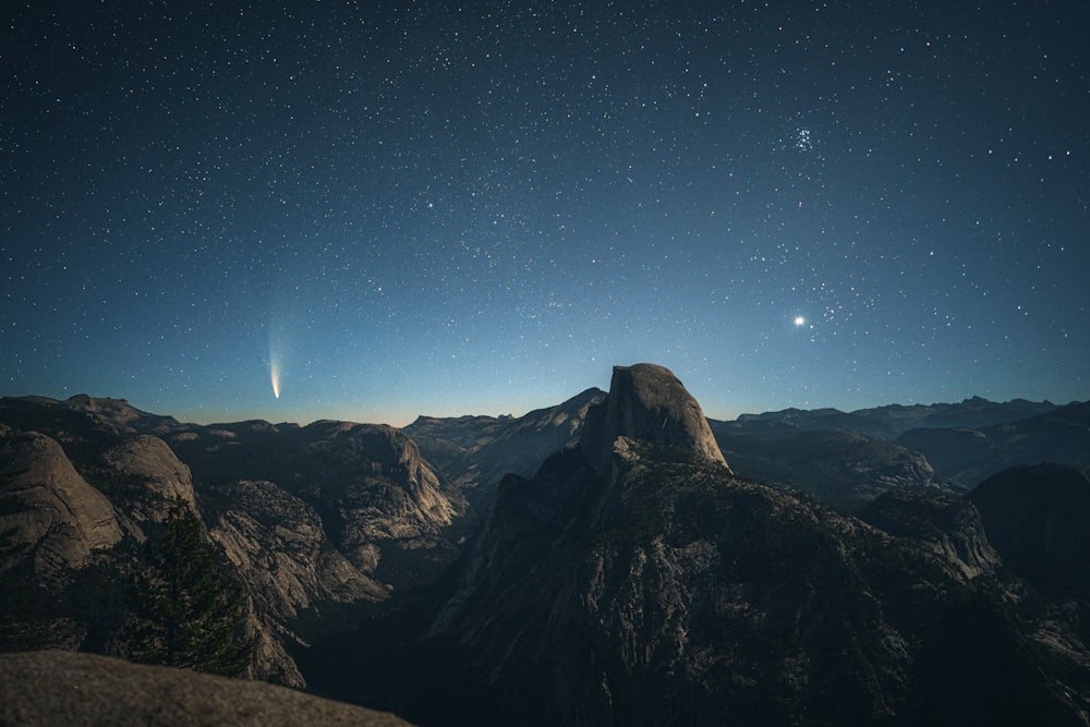 brown rocky mountain under blue sky during night time