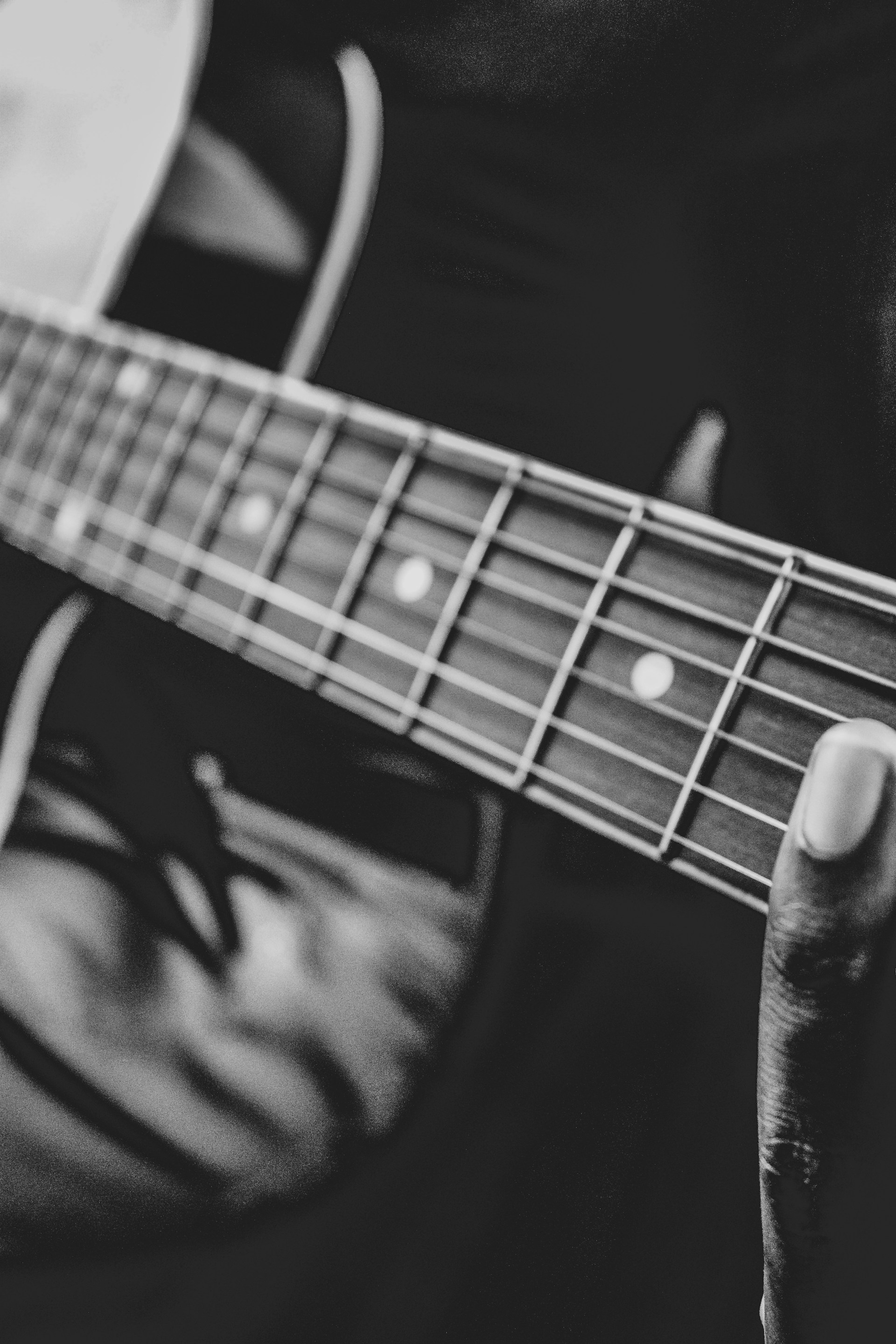 A close-up shot of a musician’s hands skillfully playing an acoustic guitar, emphasizing texture and passion in the moment.