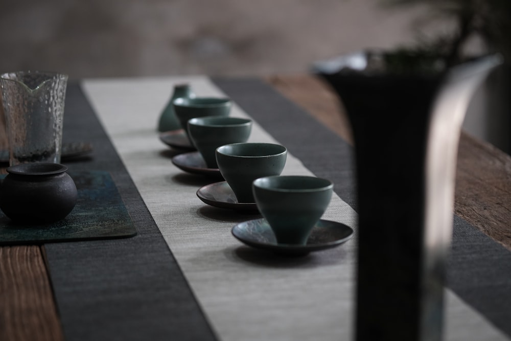 white ceramic bowls on black wooden table