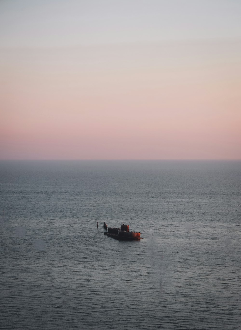 black boat on sea during daytime