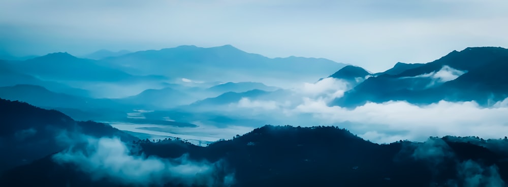 silhouette of mountains under cloudy sky during daytime