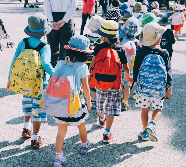 A cheerful family packing a colorful backpack with snacks and toys for a day trip.