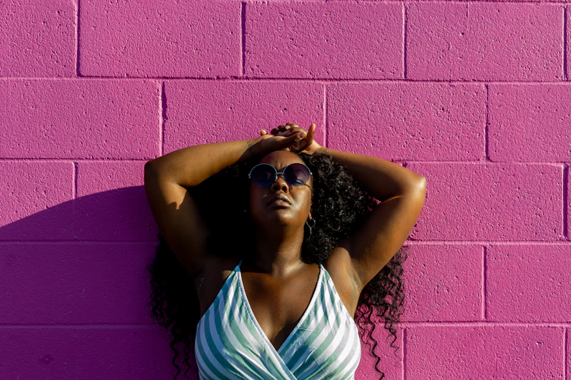 BBW woman in white tank top and black sunglasses