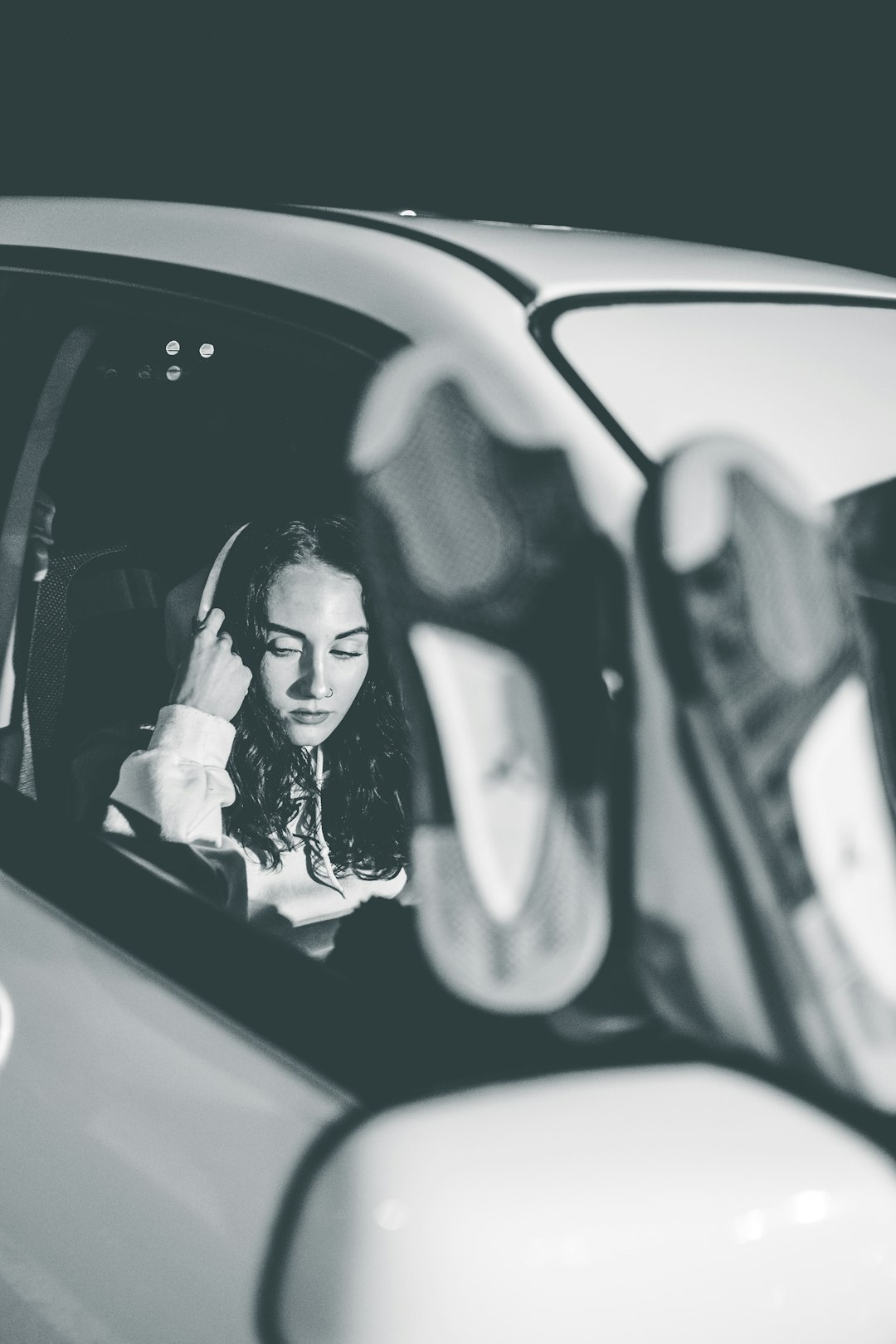 woman in car in grayscale photography