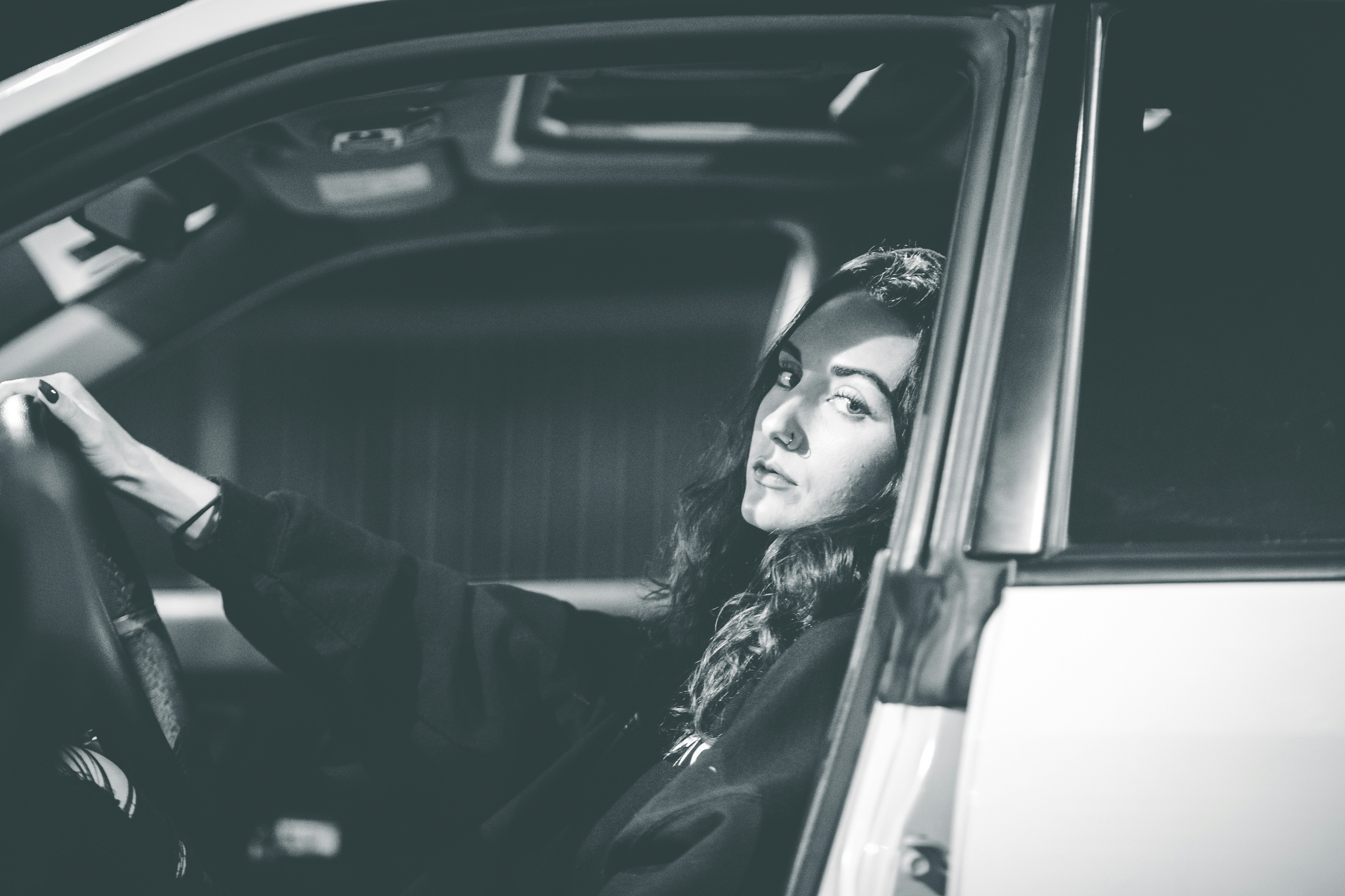 woman in black jacket sitting inside car
