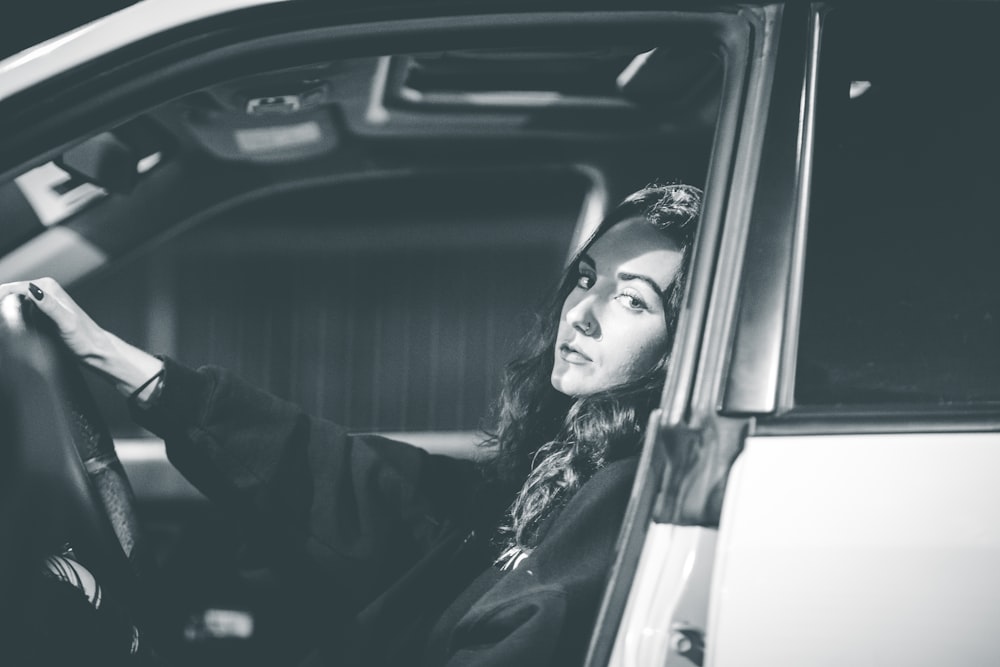 woman in black jacket sitting inside car