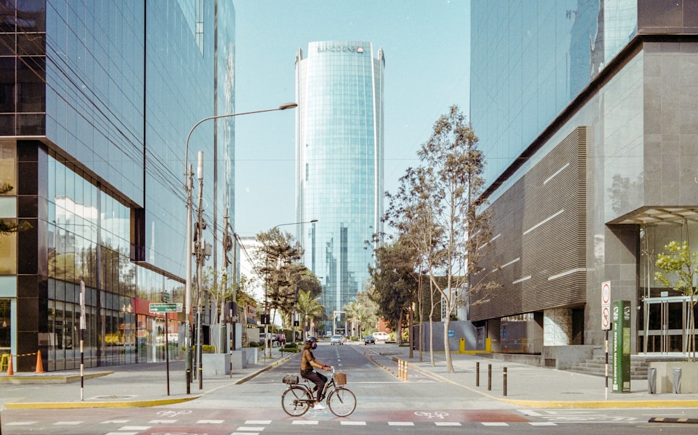 man in black jacket riding bicycle on road during daytime