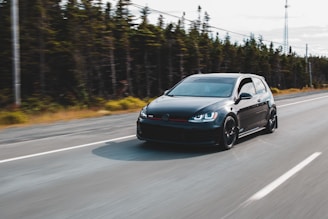 black sedan on road during daytime