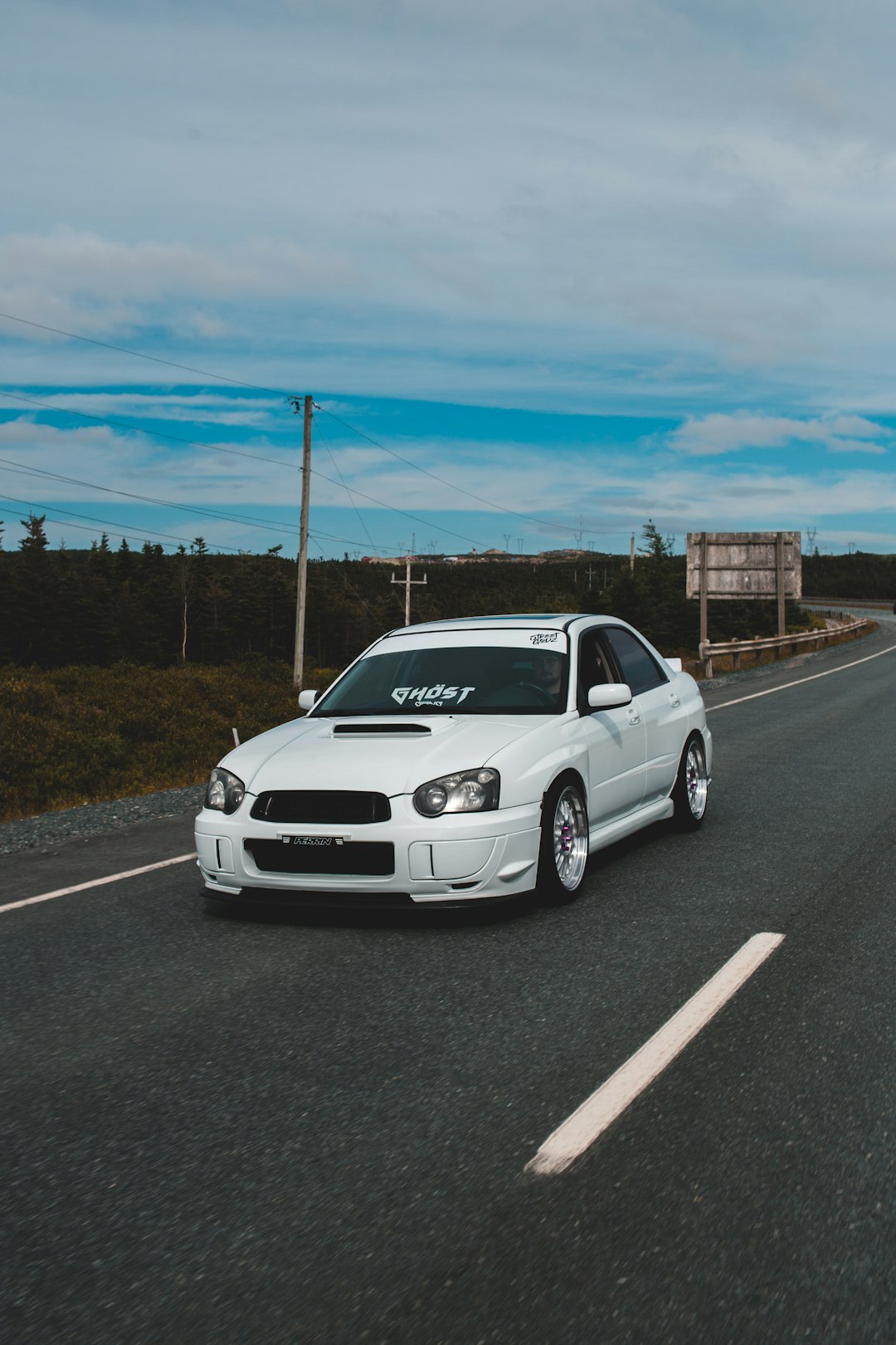 white honda sedan on road during daytime