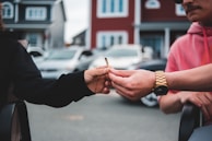 A close-up of hands exchanging a joint, symbolizing connection at a Spark and Match event.