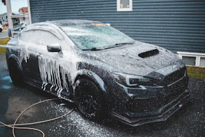 Clay bar treatment on black sedan 
