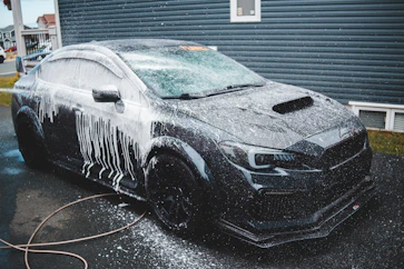 Clay bar treatment on black sedan 