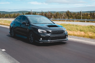 A sporty sedan in motion on a highway.