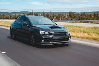 A sporty sedan in motion on a highway.