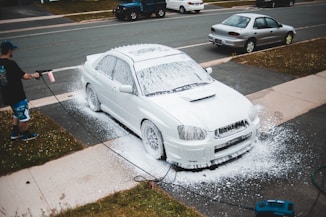 white bmw coupe on road during daytime