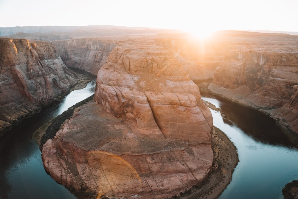 brown rock formation near body of water during daytime