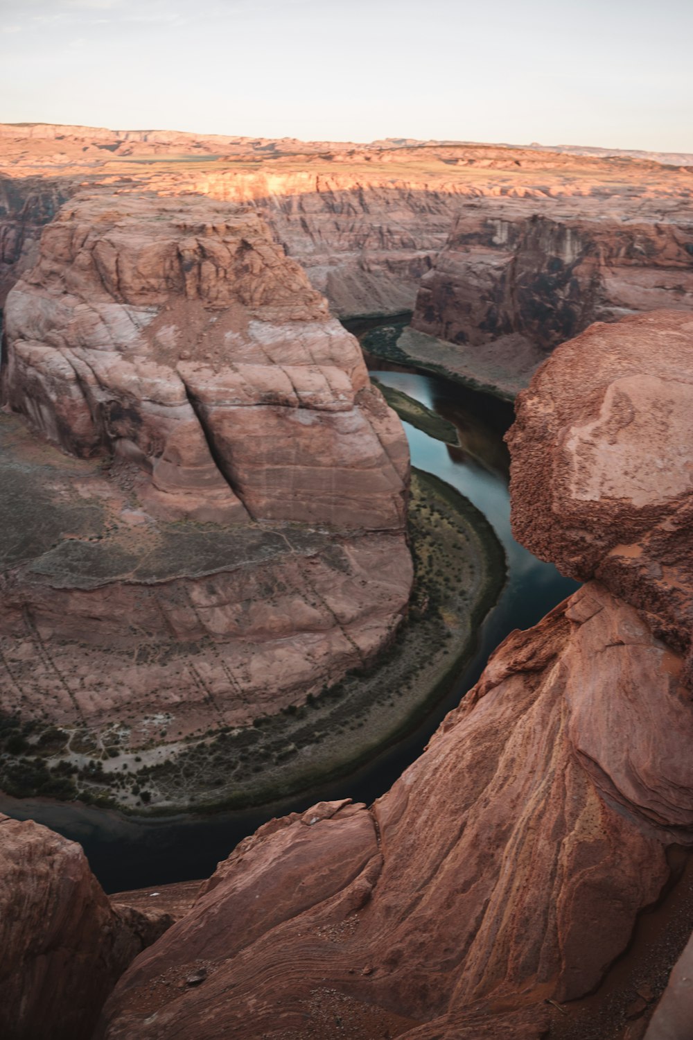 brown rock formation near body of water during daytime