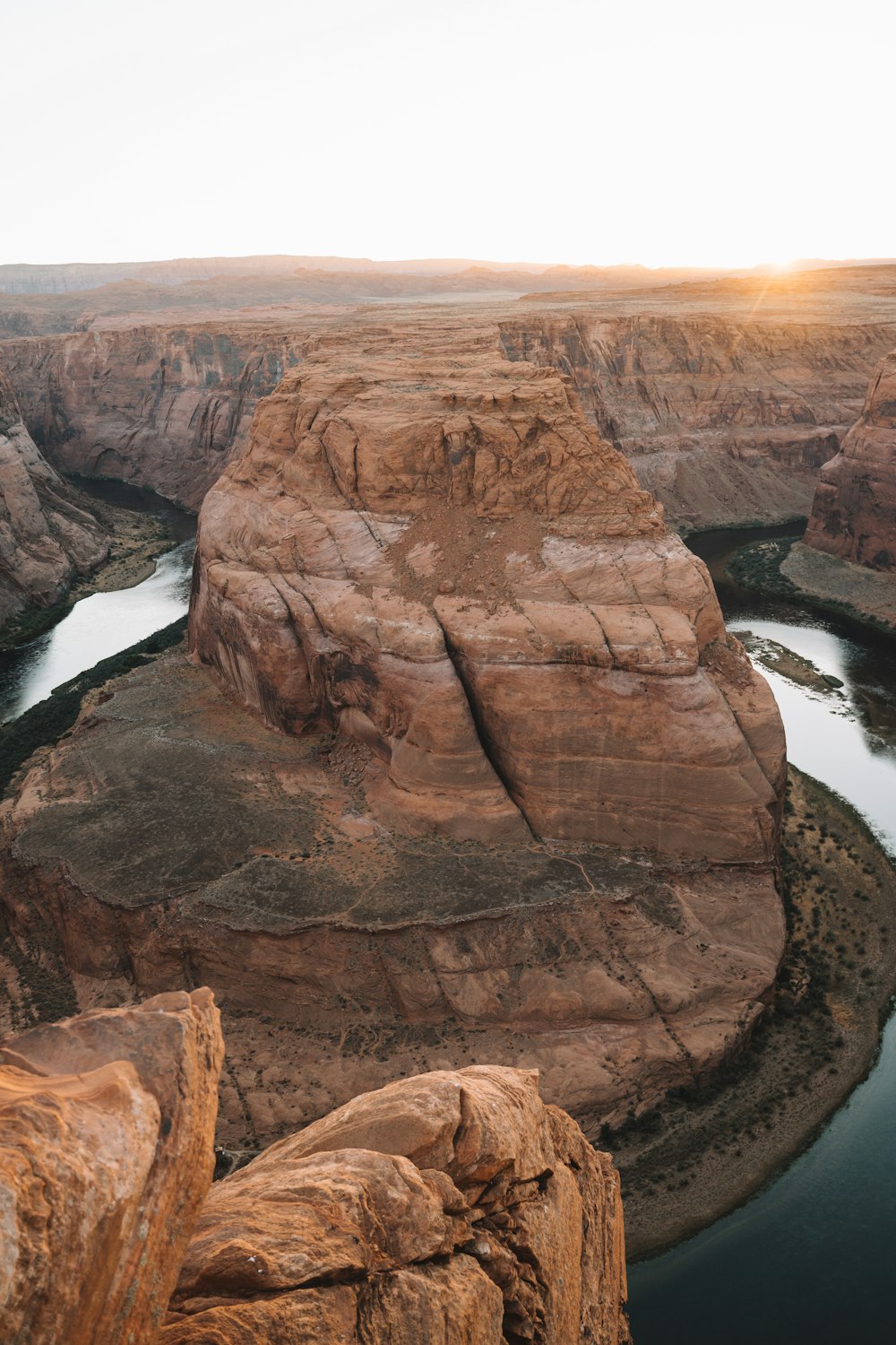 brown rock formation near body of water during daytime