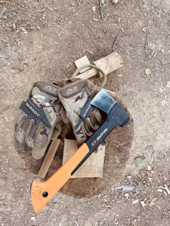 A pair of rugged work gloves resting beside construction tools.