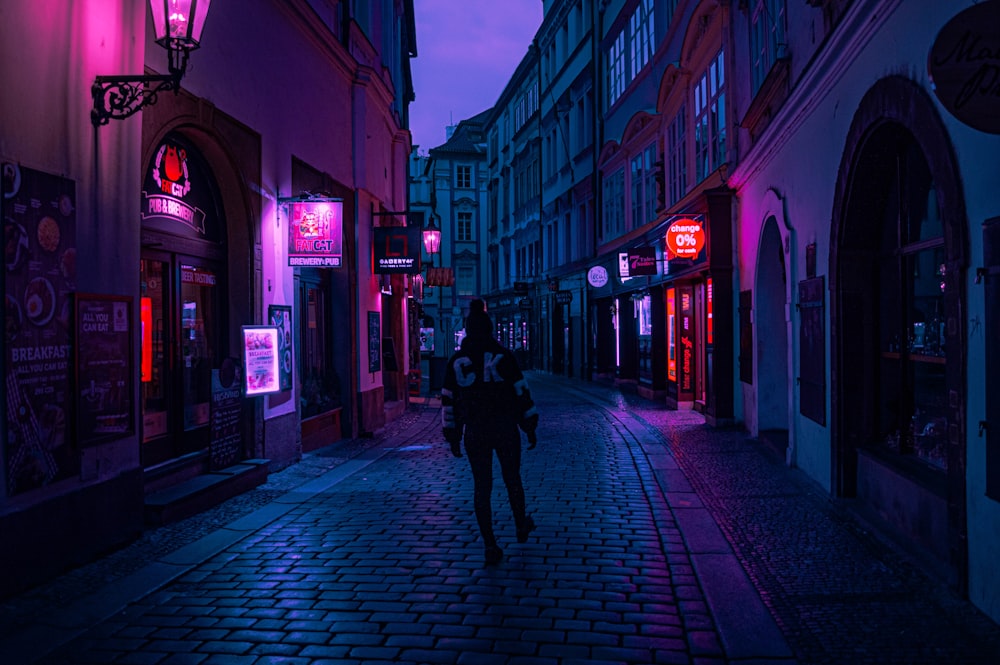 woman walking on street during night time