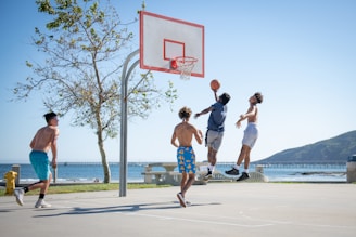 2 women playing basketball during daytime