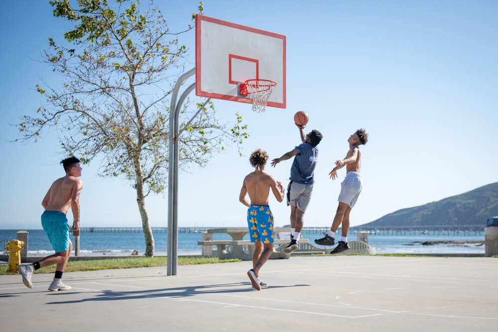 2 women playing basketball during daytime