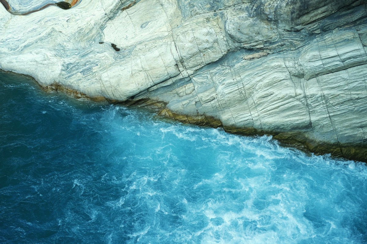 Turquoise water running between rock walls