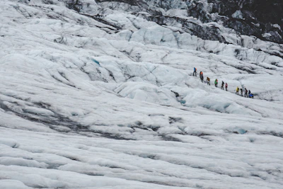 Happy travelers exploring a glacier on a sunny Icelandic day.