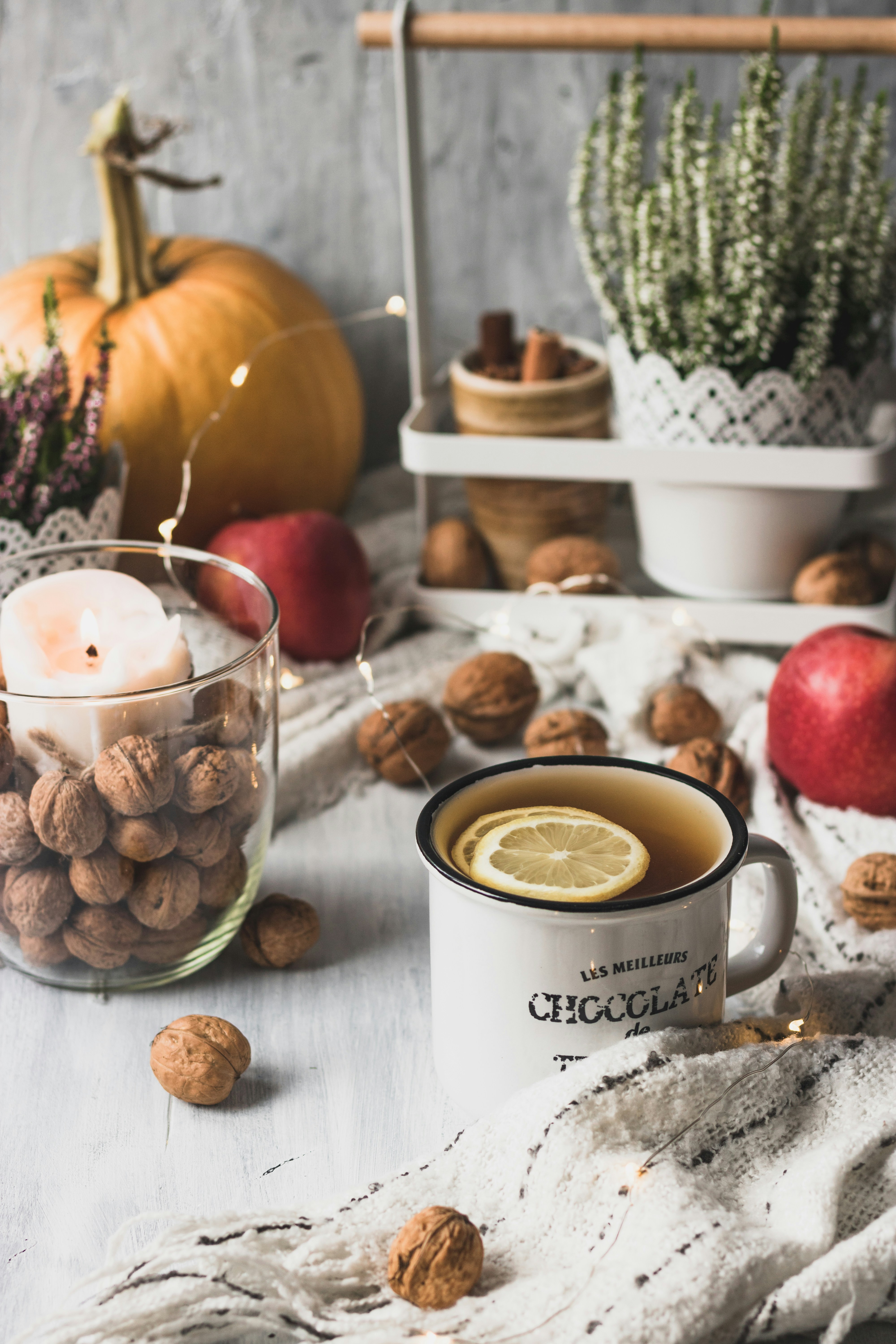 clear drinking glass beside red apple fruit