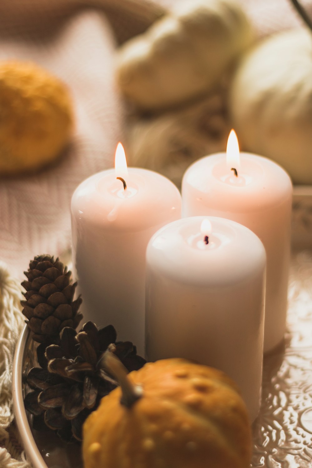 white pillar candle beside brown cookies