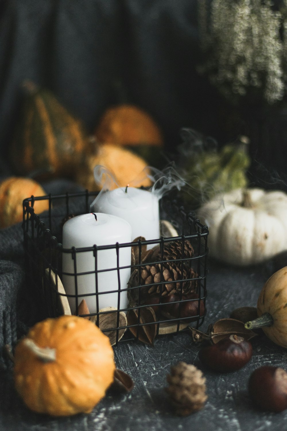 white pillar candle on black metal candle holder