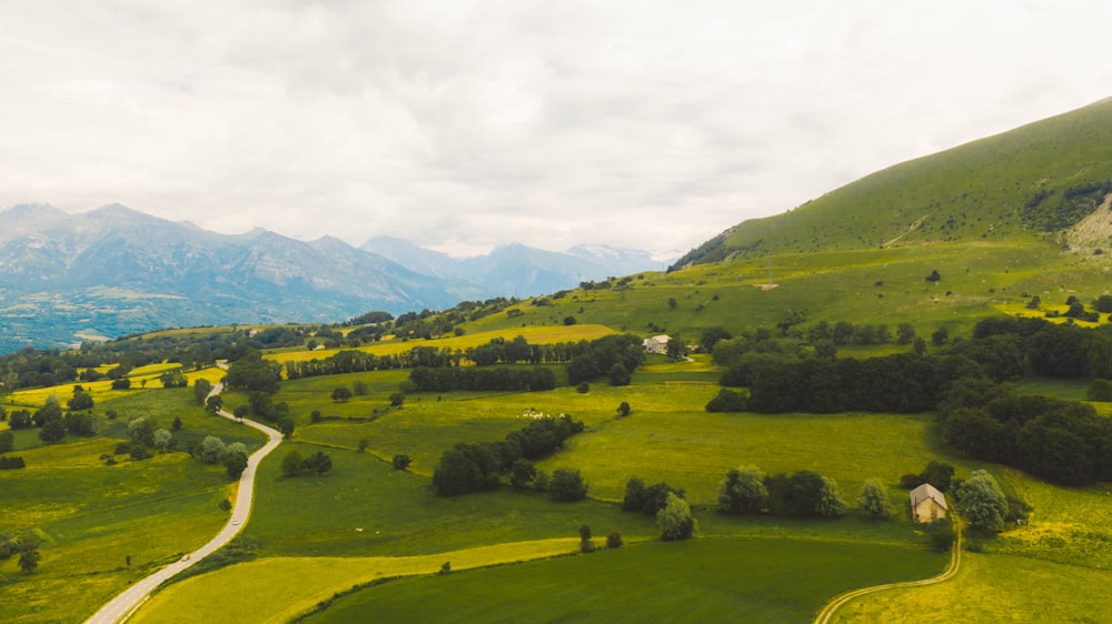 green grass field near mountain during daytime