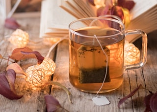 clear glass mug with brown liquid inside