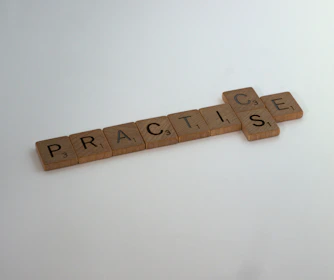 brown wooden cross on white surface