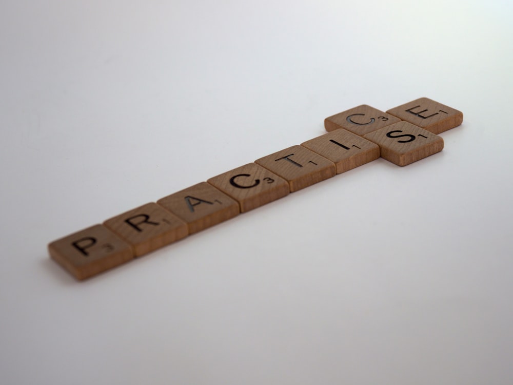 brown wooden cross on white surface