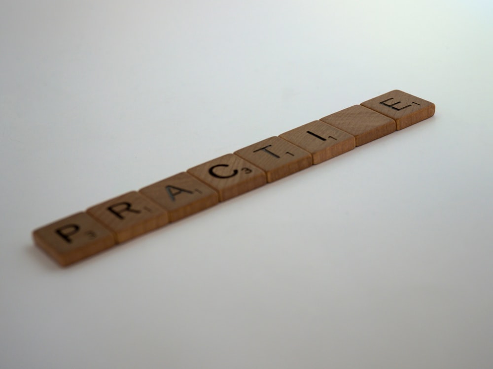 brown wooden ruler on white surface