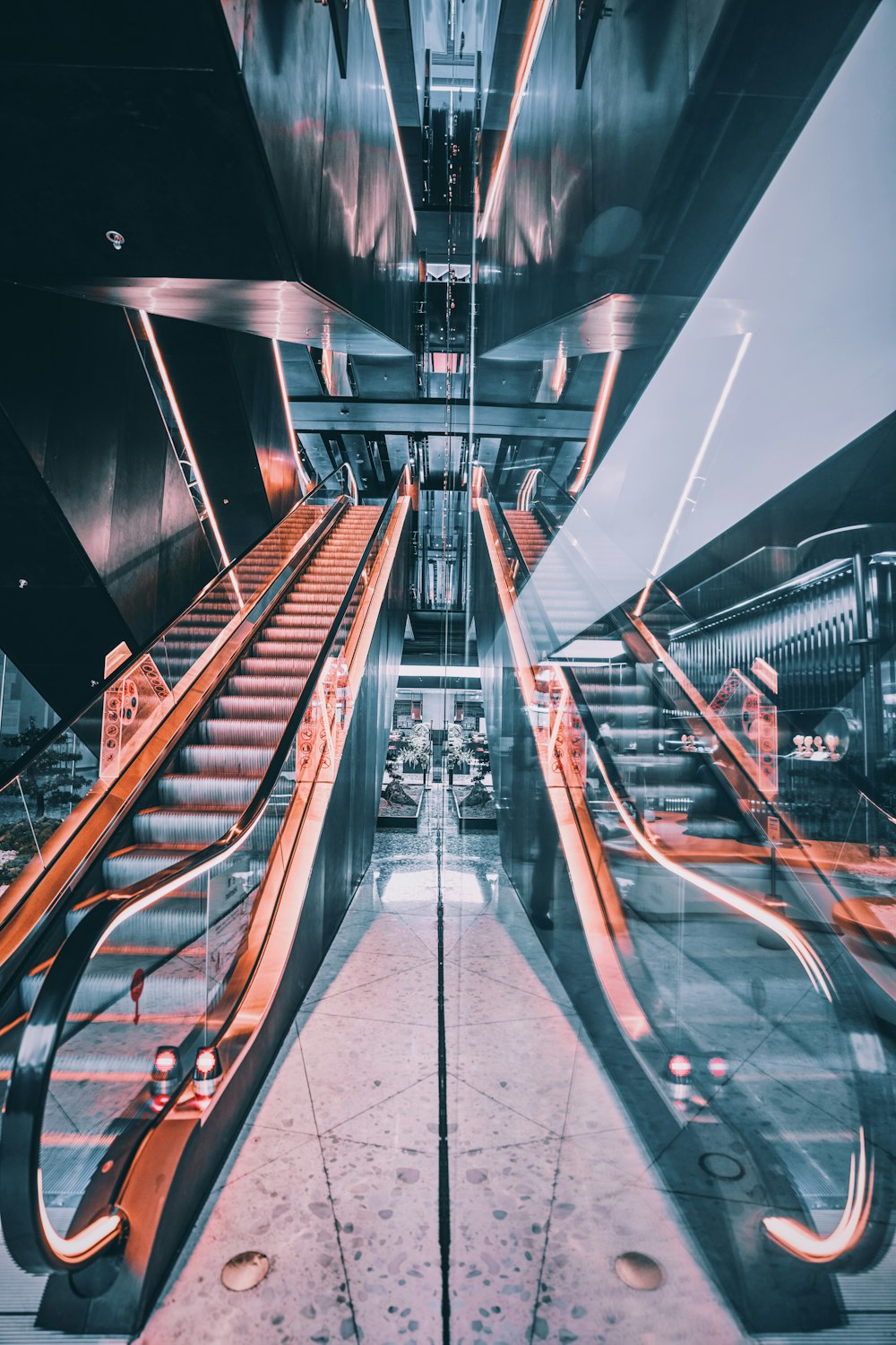 brown and gray escalator in a white room