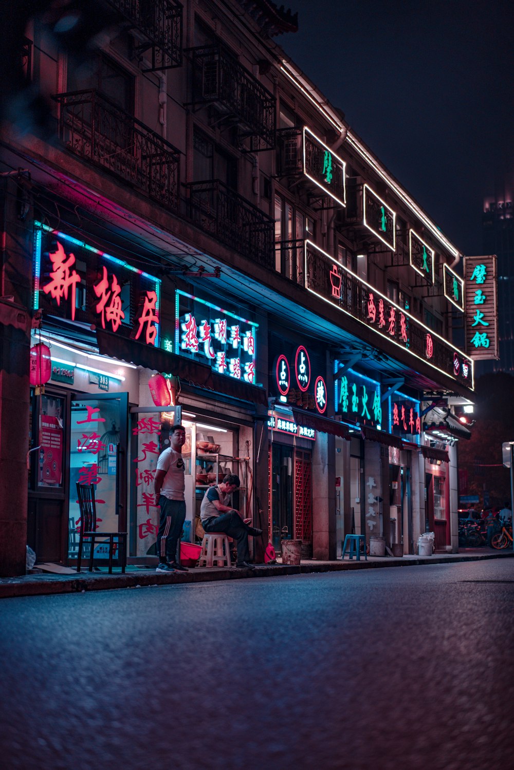 people walking on sidewalk near store during night time