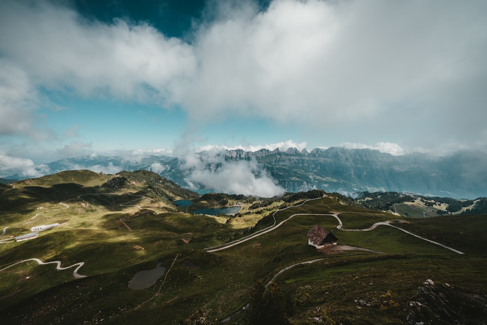 green and brown mountains under white clouds and blue sky during daytime