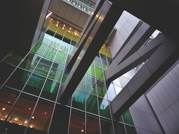 Modern industrial facility with emerald green and anthracite gray accents showcasing circular economy processes.