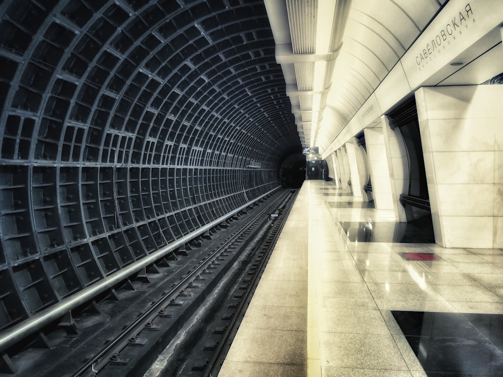 gray and brown tunnel with lights