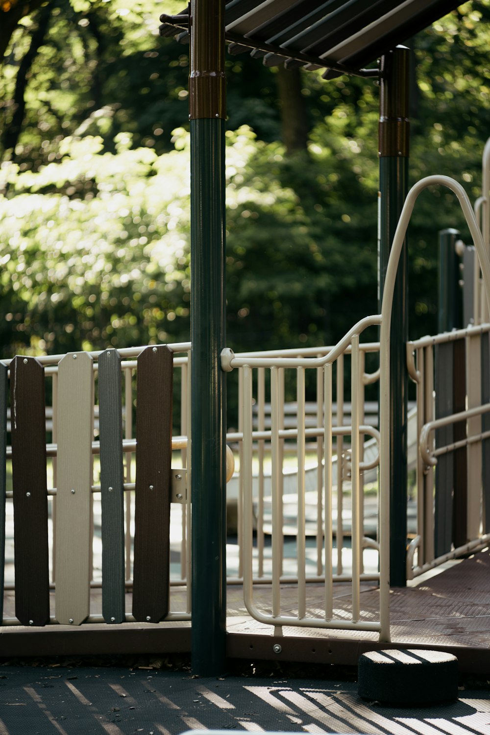 black wooden fence near green trees during daytime