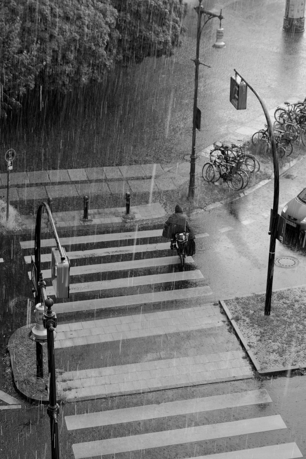 grayscale photo of man sitting on bench