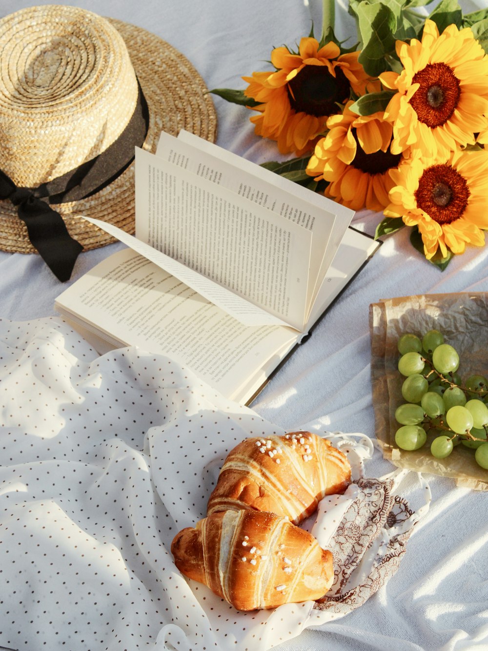 white printer paper beside brown wicker hat