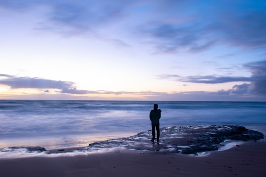 man standing on beach shore during daytime in Adelaide SA Australia