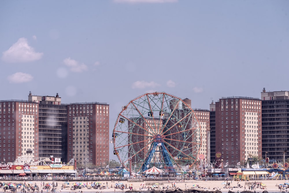 ferris wheel near city buildings during daytime